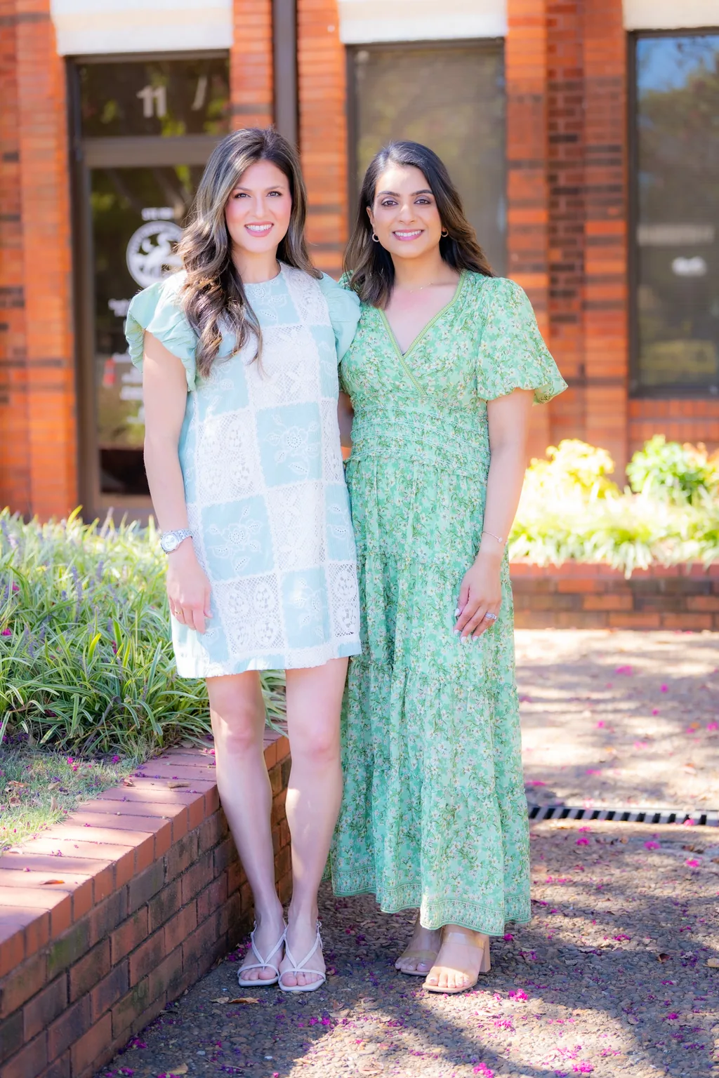 Julia Klug, PA-C and Priya Patel, PA-C standing together outside their Huntsville office